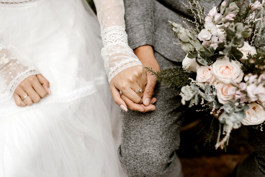 Elegant bridal hands gently touching, representing the intimate and personalized wedding services offered.